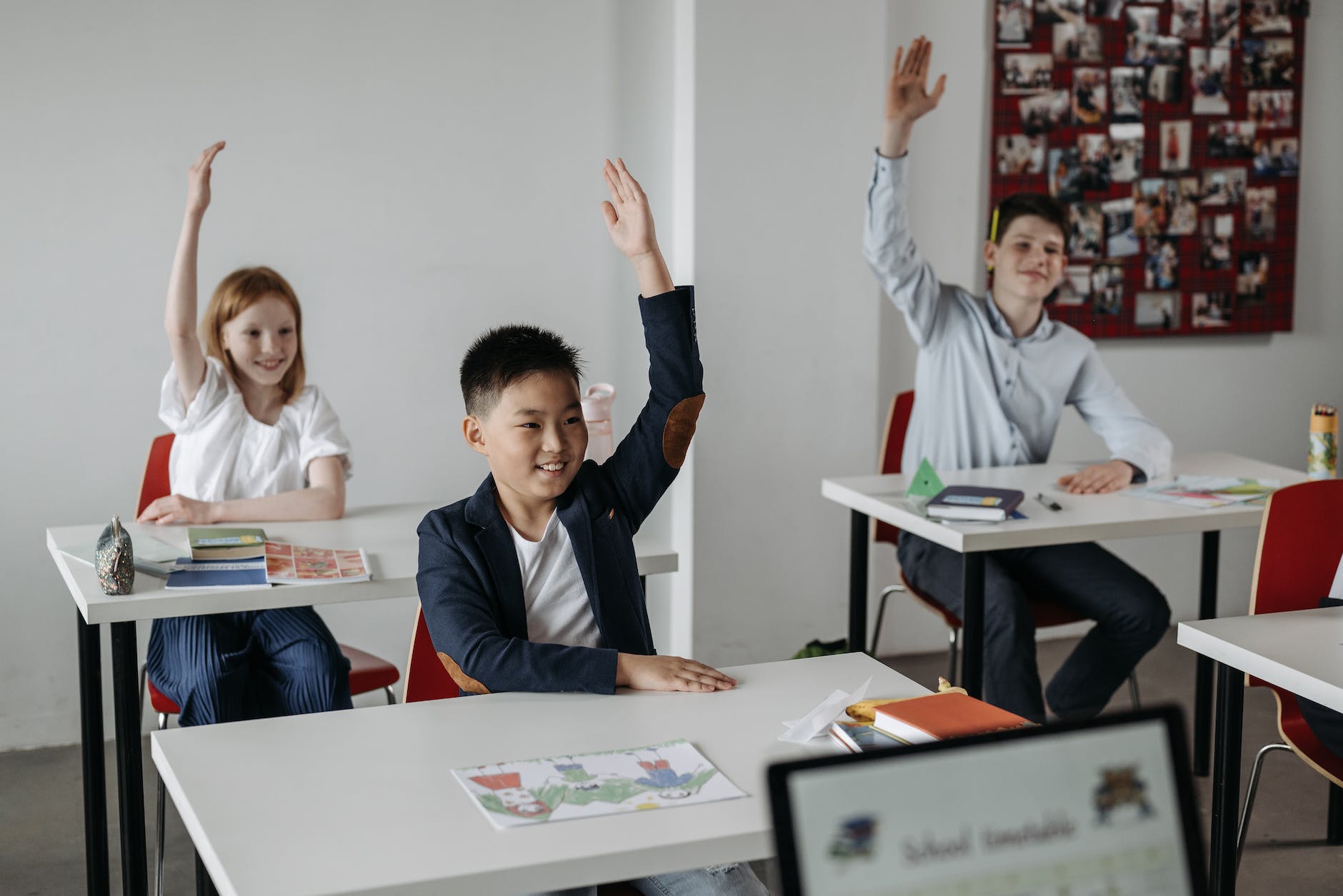 students raising their hands