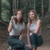 photo of women kneeling near bubbles